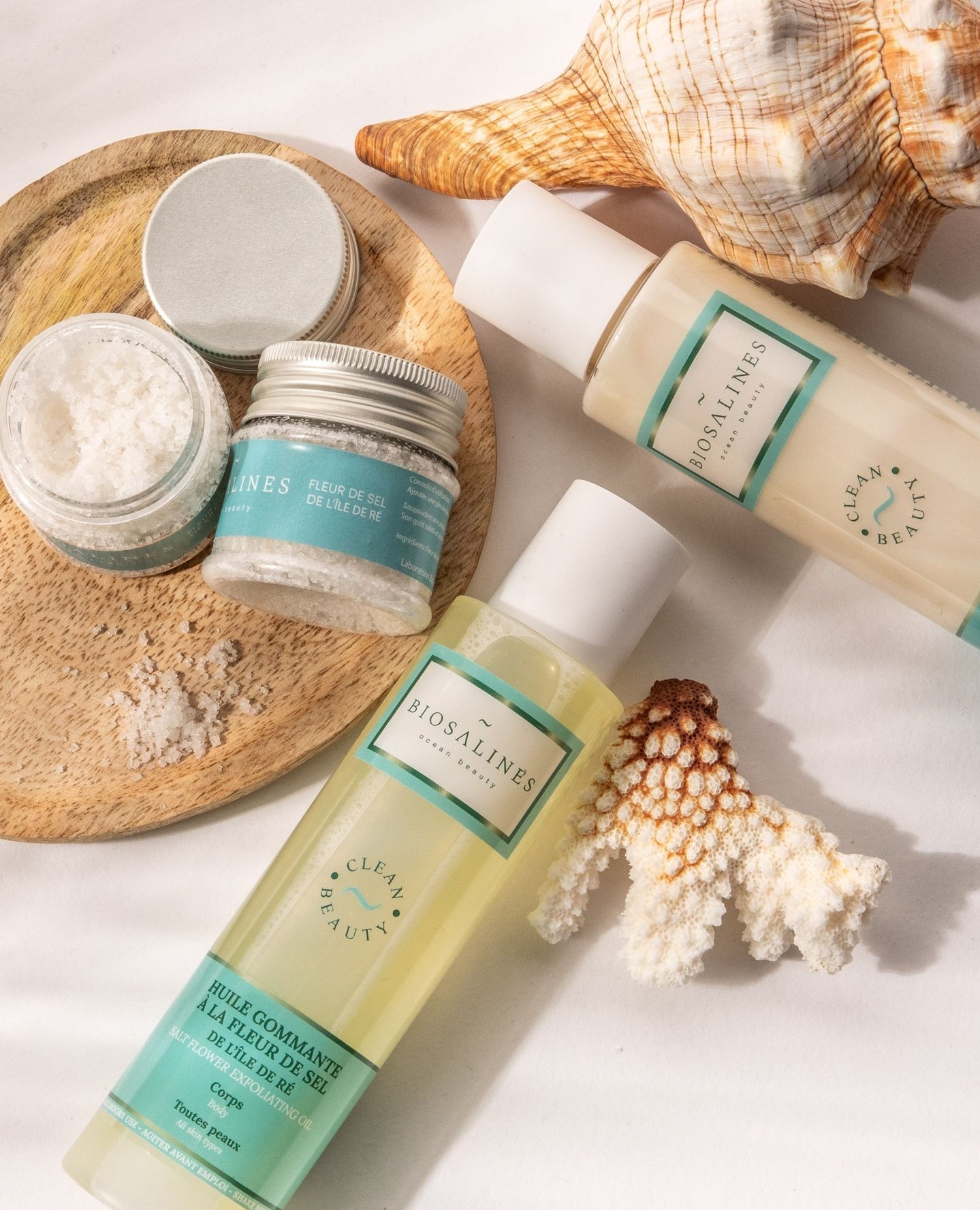 Biosalines skincare, sea salt and seashells on a pearl background